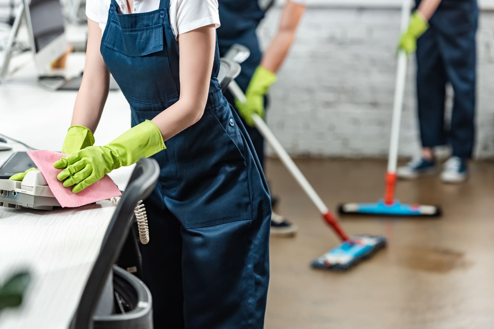 cropped view of cleaner wiping phone